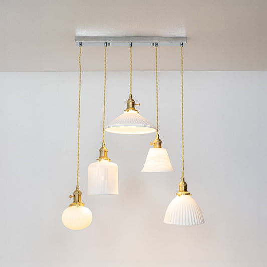 White glass and gold metal pendant lights showcasing refined designs for stylish home decor spaces.