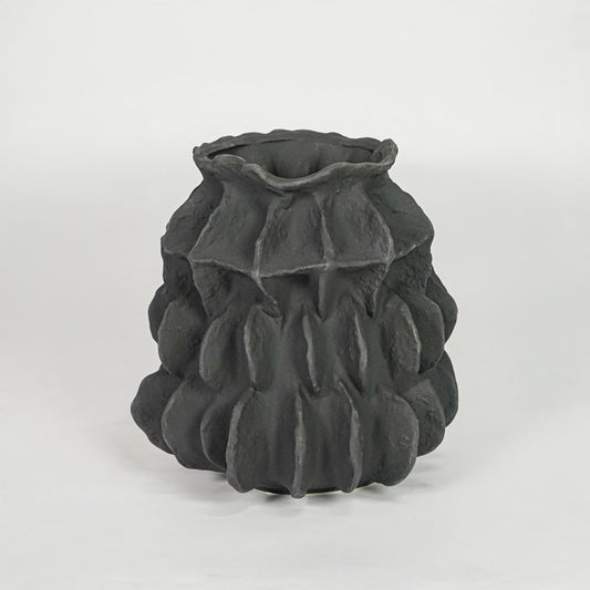 black textured round ceramic vase white background