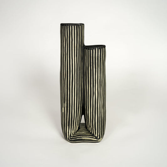 Modern black ceramic dual opening vase with striped texture ideal for console styling and home decor display.