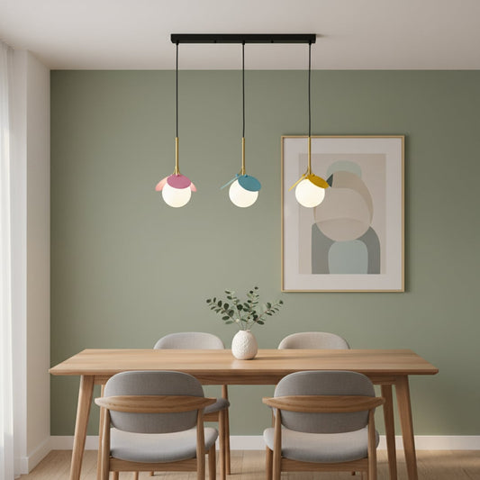 Modern colorful pendant light with frosted globes and gold rods hanging above a clean minimal room adding a playful decorative touch with soft ambient lighting.