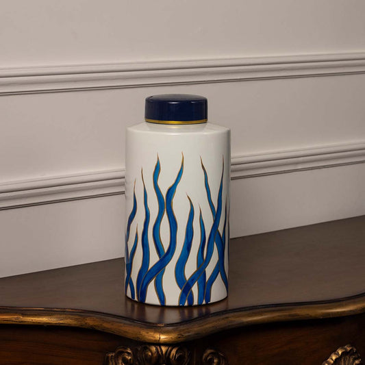Elegant white ceramic jar with blue wave pattern and golden accent lid perfect for modern luxury home decor.