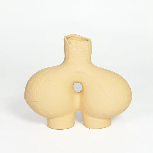 Contemporary beige ceramic decorative vase with unique hollow center for minimalist home decor styling.