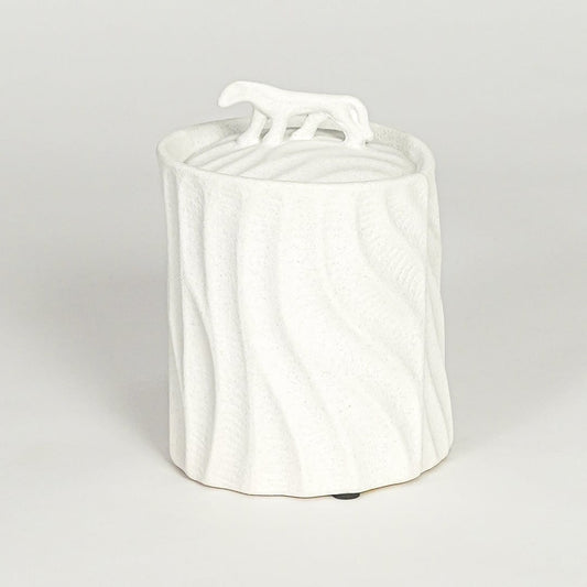 Modern white ceramic statement jar with organic textured surface and sculpted lid for coffee table console or shelf styling.