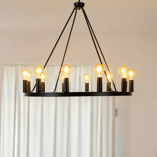 Modern black metal ring chandelier with candle lights for dining room and luxury home interiors with warm lighting.
