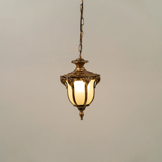 Gold metal hanging outdoor lantern with glass panels glowing on white background perfect for gate entrance and exterior decor lighting.