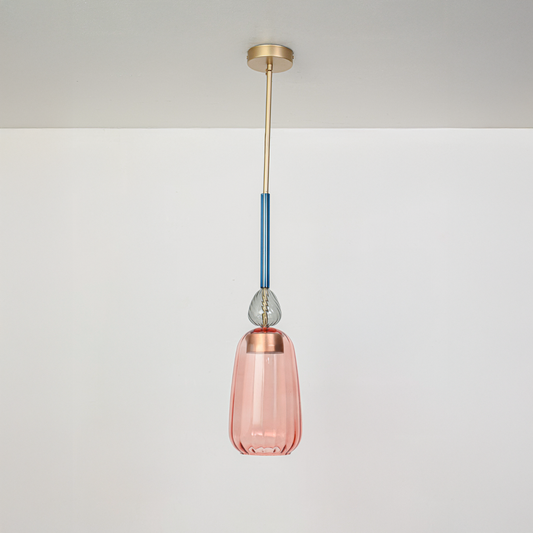 Pink glass pendant light with blue stem and gold fittings designed for contemporary interiors.