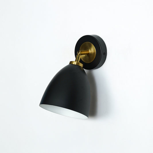 Elegant black and gold metal wall light with cone shade for stylish modern bedroom and hallway decor styling.