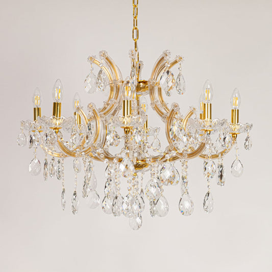 Gold crystal chandelier with ornate crystal arms shown on a white background for elegant home decor inspiration.