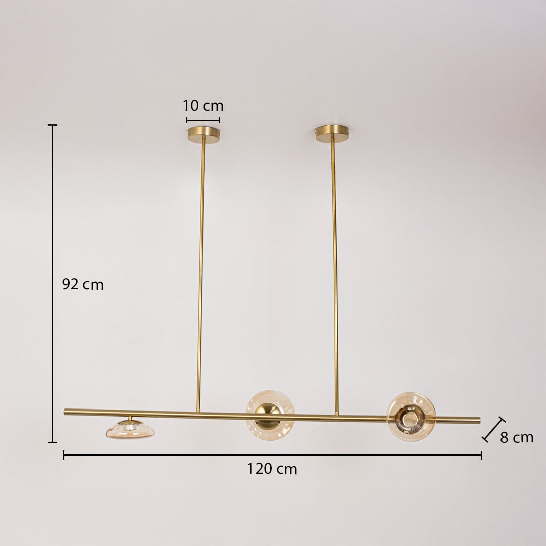 Golden metal chandelier with amber glass discs measuring 92 cm height and 120 cm width ideal for dining room ceiling decor.