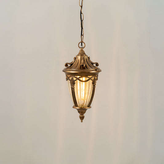 Gold metal hanging outdoor lantern with glass panels glowing on white background ideal for porch entrance and exterior decor lighting.