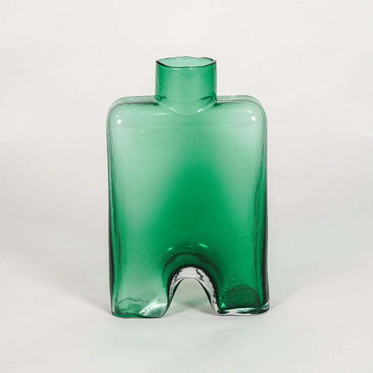 Green decorative art glass vase on white background modern home decor accent piece for table shelf console styling interior.