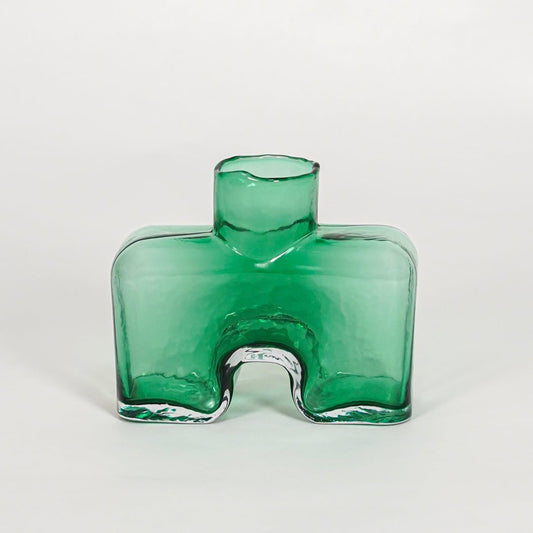 Green decorative art glass vase on white background modern home decor accent piece for table shelf console styling interior.