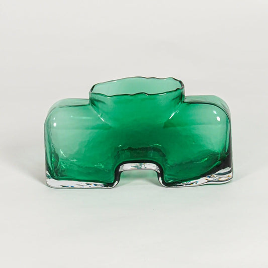 Green decorative art glass vase on white background modern home decor accent piece for table shelf console styling interior.