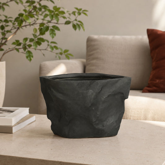 Closeup image of black ceramic planter vase for modern living room tabletop decor with artistic matte finish.