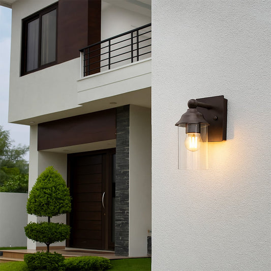 Elegant bronze wall sconce with clear glass shade adding warm accent lighting for hallways and living spaces.