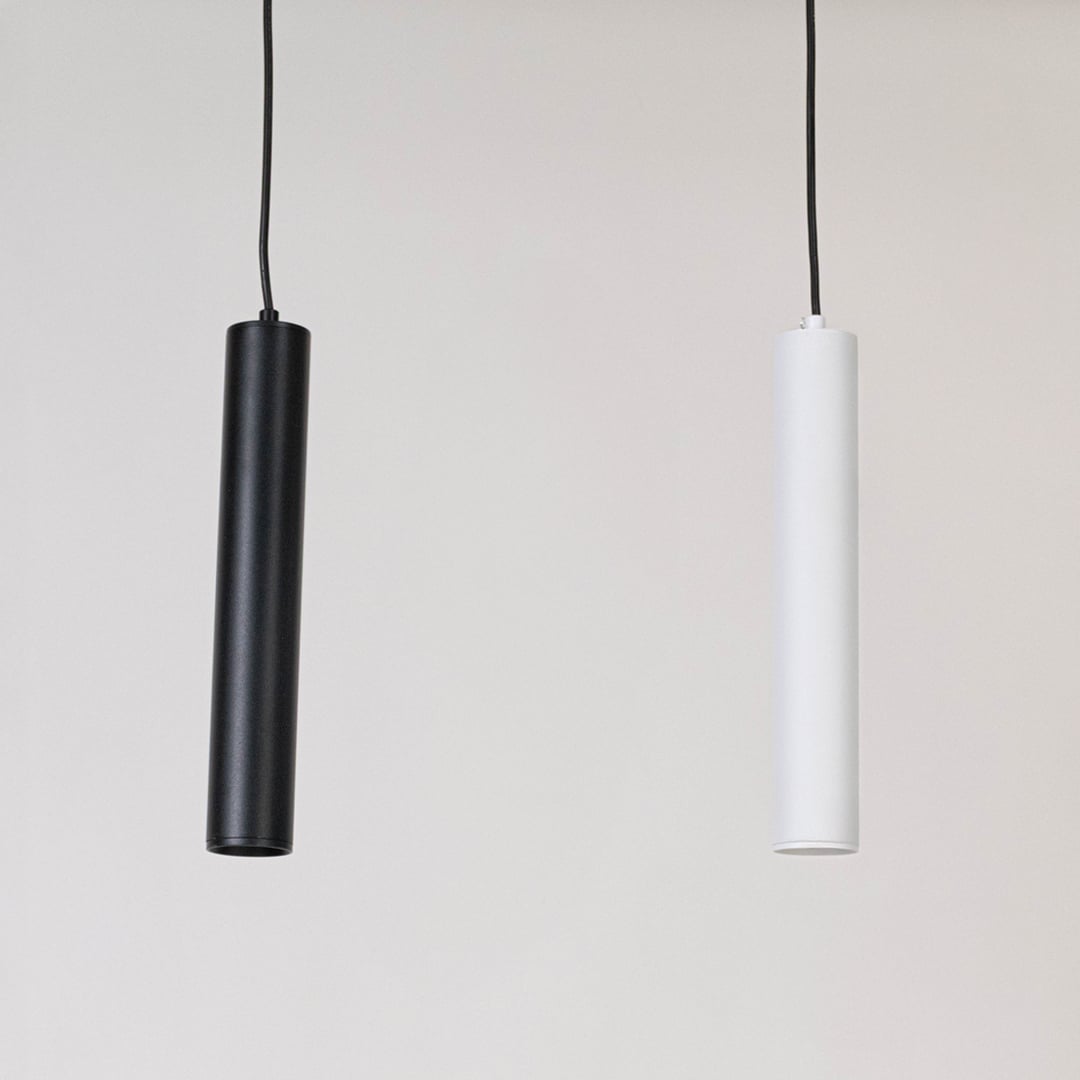 White tubular pendant lights displayed together on a white background with lights off showing minimalist style.