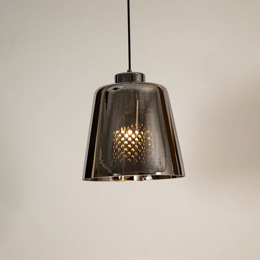 Smoked grey glass pendant light glowing warmly on white background showcasing its modern reflective shade for stylish interior lighting.