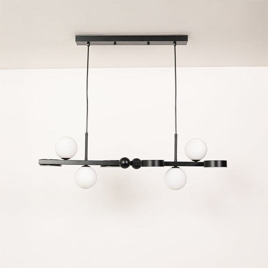Black metal chandelier with white globe shades displayed with lights off on a clean white background showcasing its modern linear silhouette.
