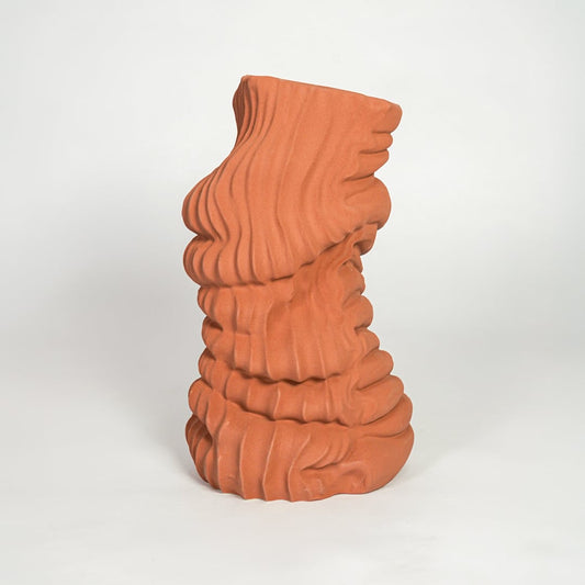 Terracotta abstract ceramic floor vase on white background modern statement decor piece for contemporary interiors.
