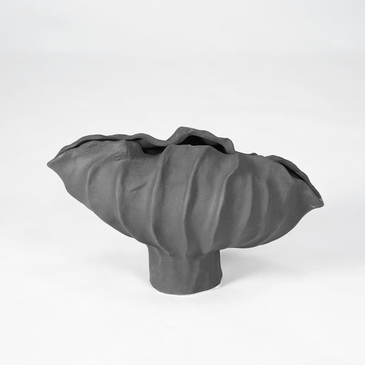Black sculptural ceramic bowl for stylish coffee table placement and contemporary indoor home decor styling accent.