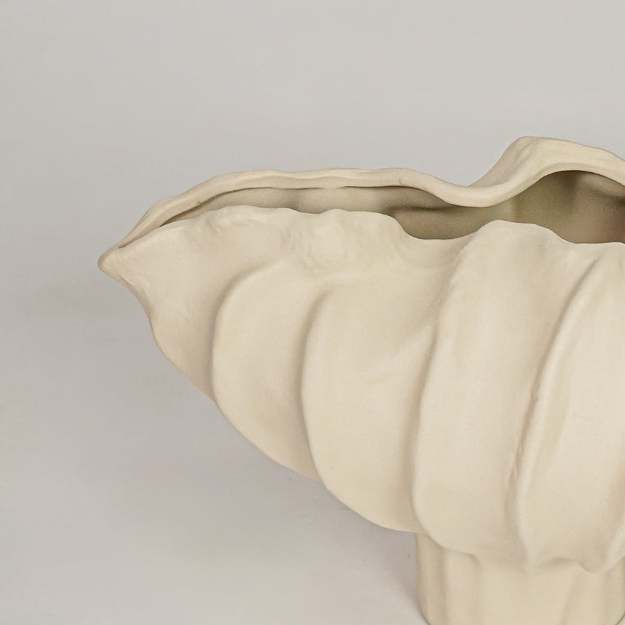 Closeup of beige ceramic bowl with sculpted wave texture for luxury tabletop and console decor styling ideas.