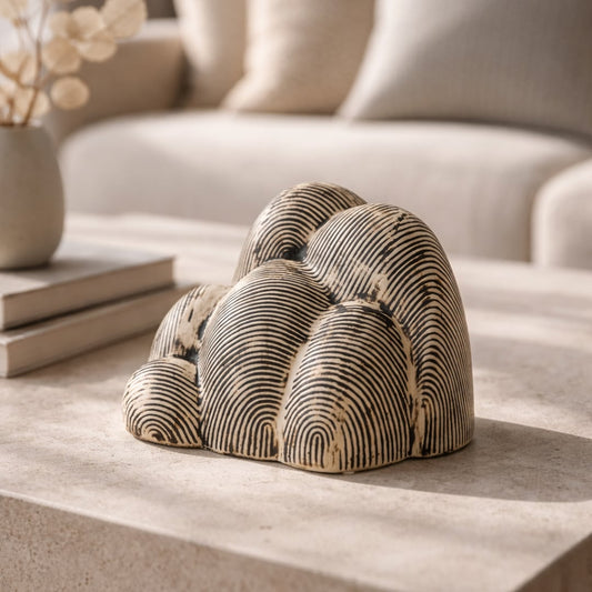 Beige textured ceramic decor sculpture placed on table modern decorative showpiece for living room console home decor styling.