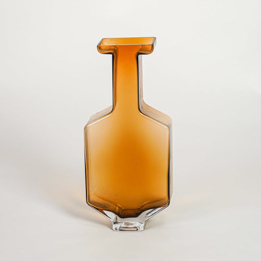 Amber decorative art glass vase on white background modern home decor accent piece for table shelf console styling interior.