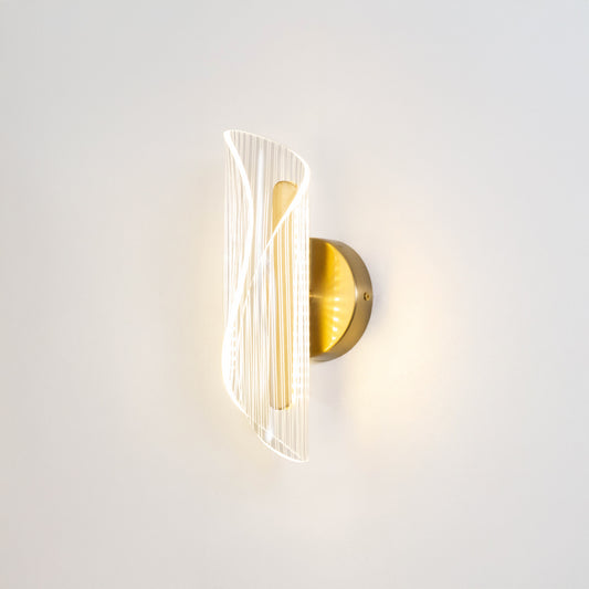 Modern wall light in gold metal finish with sculpted glass design for bedroom or living room decor lighting white background.