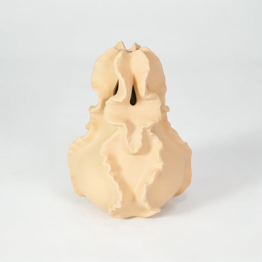 Beige sculptural ceramic vase for modern shelf placement and artistic indoor home decor styling accent piece.
