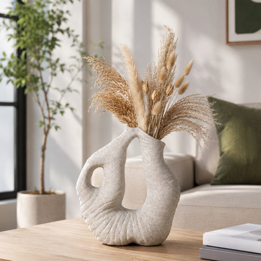Beige abstract sculptural vase with dried grass on wooden table for elegant modern home decor and cozy living space.