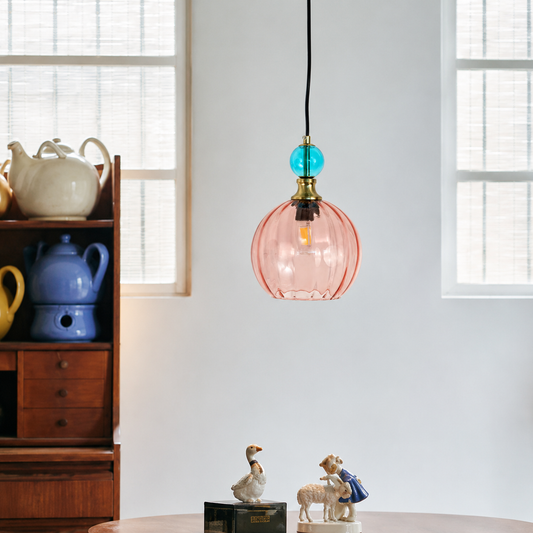 Lifestyle image of danish glass ball chandelier in red and blue for elegant dining room decor styling and modern lighting.