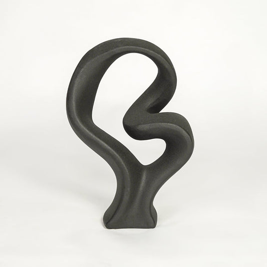Black sculptural decor object on white background modern abstract statement piece for contemporary interior styling.