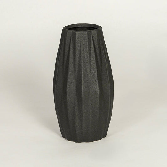 Modern black ceramic statement vase with sculpted ribbed body for coffee table console or shelf display.