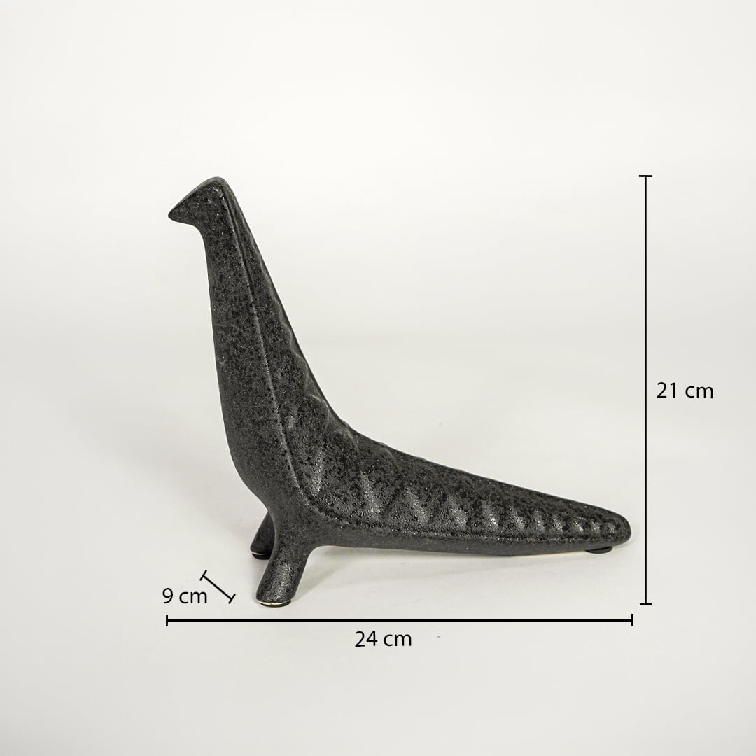 Dark grey ceramic decor sculpture showing 24 cm length 21 cm height and 9 cm width on white background.