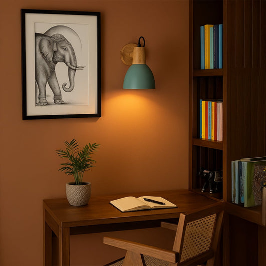 Modern wall light with teal blue shade wooden base and black cord glowing warmly in a stylish study and living room wall decor.