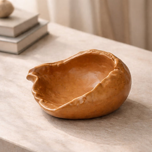 Brown ceramic decorative bowl placed on table modern centerpiece bowl for living room console home decor styling.