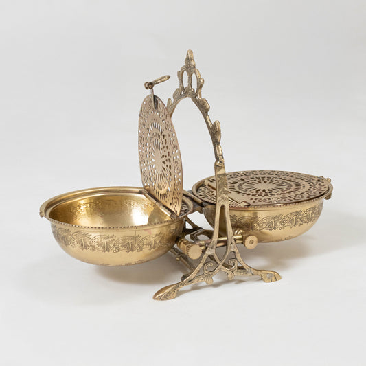 Decorative metal basket set in gold finish with handle for dining table or serving decor accessory placement white background.