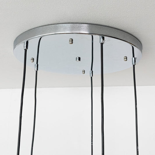 Close view of copper teardrop pendant shades showing their smooth reflective metal finish and sculpted modern shape for premium interior lighting.