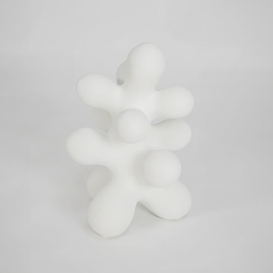 White abstract decor sculpture for modern shelf placement and elegant indoor home decor styling accent piece.