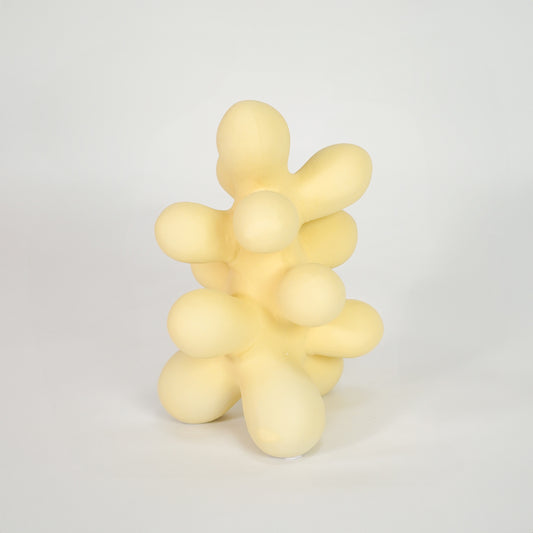 Yellow abstract decor sculpture for modern coffee table placement and artistic indoor home decor styling accent.