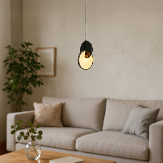 Luna disc pendant light turned off featuring circular design with metallic finish and clean white background.
