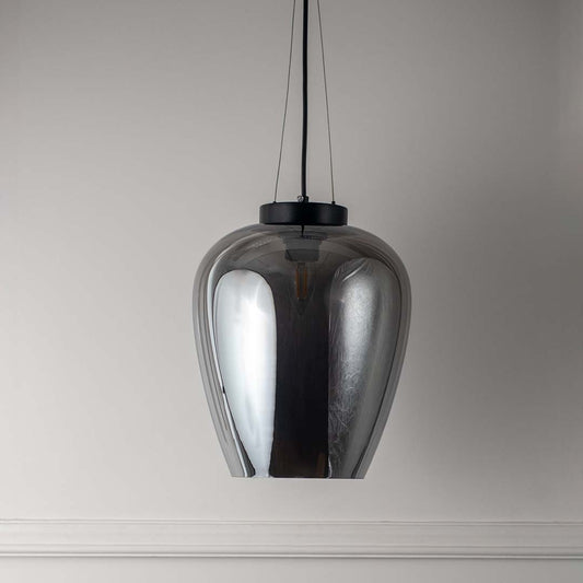 Modern pendant light with glossy metallic shade on neutral background minimal hanging lighting for contemporary interiors.
