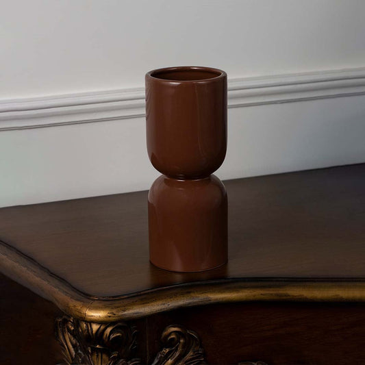 Brown ceramic vase with glossy finish placed on a white background for modern home and office decor.