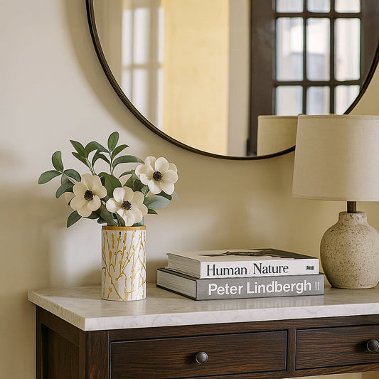 Stylish ceramic jar with golden botanical pattern and wooden lid displayed in a bright minimal setting adding a refined decorative touch.