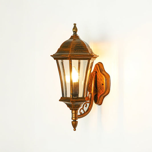 Classic outdoor wall light with bronze finish and glass enclosure on neutral background ideal for porch or entryway lighting.