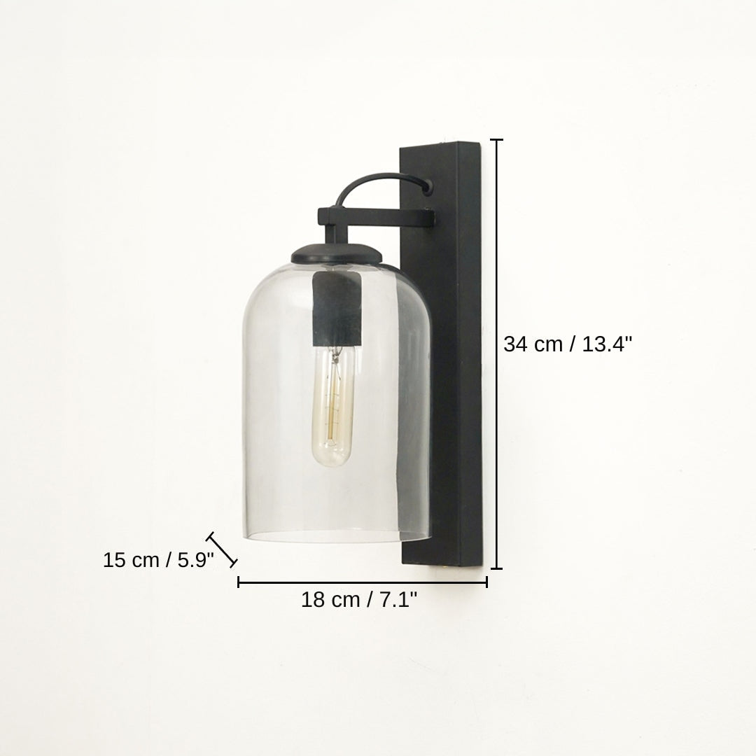 Black wall-mounted sconce with a clear glass bell shade and visible filament bulb, base 34 x 18 x 15 cm (13.4 x 7.1 x 5.9 inches), canopy 34 x 7 cm (13.4 x 2.8 inches) dimensions