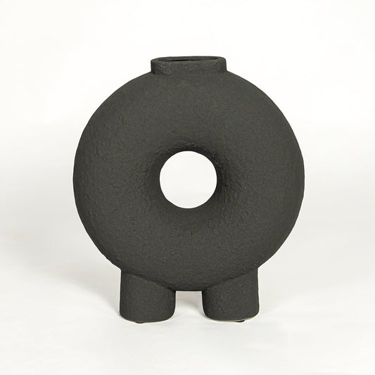 Modern black ceramic statement donut vase with hollow center for coffee table console or shelf styling.