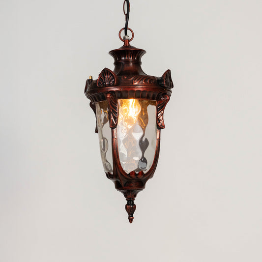 Vintage metal hanging lantern light with warm glow and clear glass shade for elegant balcony and porch decor.
