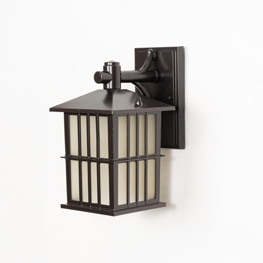 Black metal outdoor wall lantern switched off on white background emphasizing clean structure frosted glass and wall mount style.