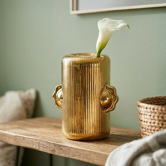 Gold metal decorative flower vase placed on table with flower modern luxury home decor styling idea.